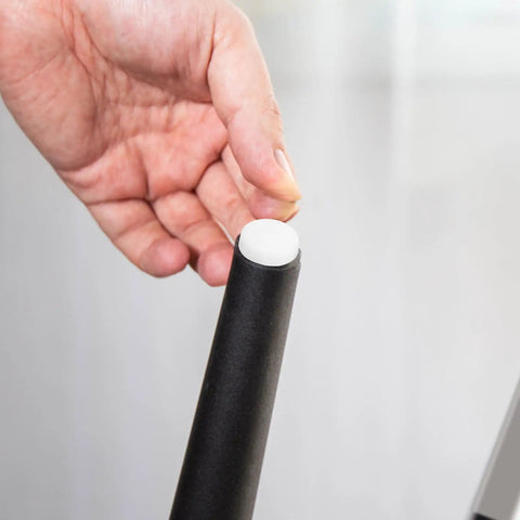 Installing Plastic Furniture Pins With Double Head And Oval Chair Feet Pads on a table leg to prevent scratches on hardwood floors.