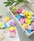 Small 1.5x2 Inch Sticky Notes, 50 Pads With 50 Sheets Each, 10 Bright Colors Recyclable Self Stick Pads spread on table