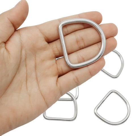 10 Pack Stainless Steel D Ring 1.5 Inch Beefy Heavy Duty Welded Rings For Tie Downs And Lashing Seamless Weld Construction No Weak Spots Load Bearing Hardware For Trailers Camping Gear Outdoor Projects, close-up in hand