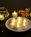 Battery Operated LED Tea Lights Set Of 100 Flameless Tealights With Warm Yellow Glow For Weddings Parties And Home Decor No Fuss Setup 200 Plus Hours Runtime Easy On Off Switch on plate and glass holder