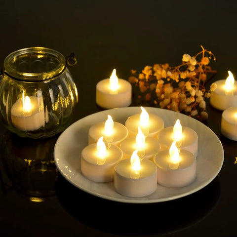 Battery Operated LED Tea Lights Set Of 100 Flameless Tealights With Warm Yellow Glow For Weddings Parties And Home Decor No Fuss Setup 200 Plus Hours Runtime Easy On Off Switch on plate and glass holder