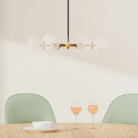 Sputnik Chandelier Dope Mid Century Pendant Light With Glass Globe Shades over dining table with green chairs