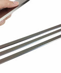 Hand holding blade from heavy duty 13 inch knife set for JPM 13 planer molder pro grade high speed steel blades 62 64 Rockwell hardened