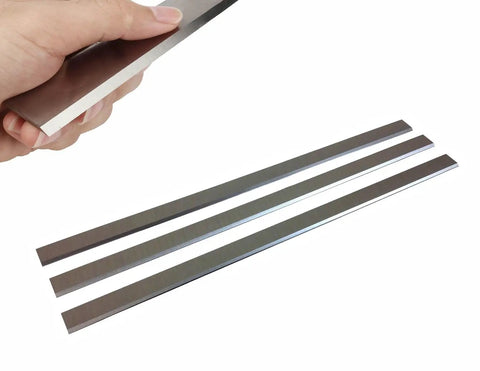 Hand holding blade from heavy duty 13 inch knife set for JPM 13 planer molder pro grade high speed steel blades 62 64 Rockwell hardened