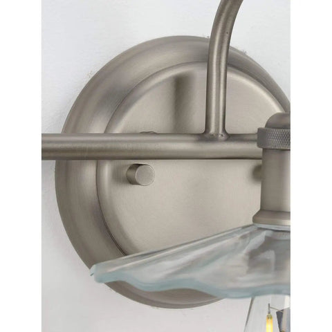 Fayette Collection 3-Light Clear Glass Farmhouse Bath Vanity Light Antique Nickel fixture showcasing round backplate and shade detail