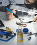 Person using 60W Soldering Iron Kit With Adjustable Temperature and 13 in 1 Pro Grade Electronics Tool Set on circuit board.