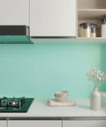 Thick Pastel Mint Metallic Peel And Stick Wallpaper With Brushed Matte Surface Gives Your Space A Straight Up Glow Up self-adhesive backsplash in a modern kitchen.