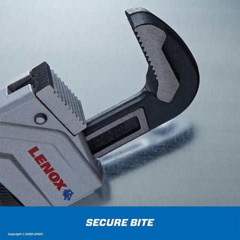 Close-up of Aluminum Pipe Wrench 24 Inch Workhorse With Forged Wide Jaws, Beefy Quick Bite Teeth on a metal surface.