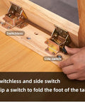 Built Tough Black Folding Table Hinge Featuring Automatic Self Locking Brackets For Heavy Duty Sofa Beds And Coffee Tables Zero To Ninety Pivot Galvanized Steel Hardware Kit with switches on wooden table.
