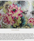 Close-up of hand painted floral designs on a ceramic tea storage jar showing rich colors and intricate detailing.