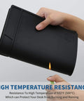 Person holding rolled Black Silicone Soldering Mat For Electronic Repairs, showcasing heat resistance against flame