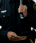 Security personnel holding Stinger DS 425-Lumen Rechargeable LED Flashlight with Dual Switches and DC Steady Charger.