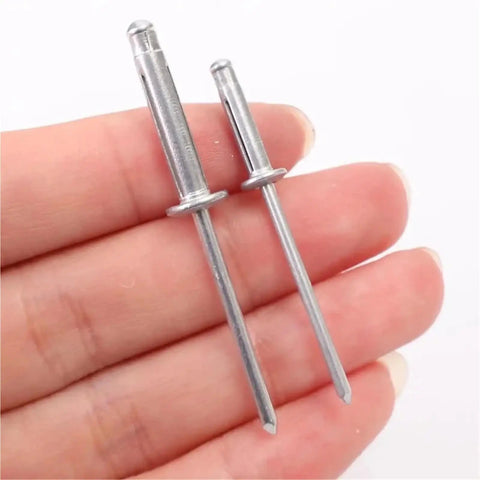 Close-up of hand holding Aluminum Alloy Blind Rivets Kit 200 Pcs M4 with round head tri-fold design for metal DIY projects.