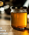 Glass jar of honey on wooden table with branding.