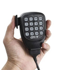 Hand holding microphone for KT-8900D Dual Band Quad Standby Ham Radio Rig 25W VHF 136 to 174 MHz UHF 400 to 450 MHz with keypad visible