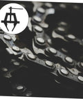 Close-up of Heavy Duty Motorcycle Chain Tensioner Chain Adjuster Tool on bike chain, showcasing durable steel construction.