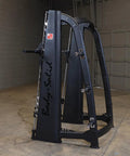 Pro Clubline Counter Balanced Smith Machine Featuring Heavy Duty Safety Stops Built Tough For Hardcore Home Gym Gainz And Commercial Powerlifting Rigs in black steel, side view.