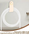 Slick Double Pack PU Leather Cord Organizer Ties For Reusable USB Charger Straps and Earphone Holders, beige leather strap holding white cables.