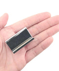 Hand holding stainless steel clip, 1.6 inches long and 0.75 inches wide, part of Glass Door Clip On Handles 4 Pack for 5-6 mm glass.