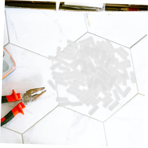 Pro Grade Nylon Hidden Fasteners For Wood Shelves And Cabinets 100 Pack on a work surface with pliers.