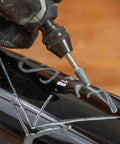 Dremel 729-01 engraving accessory close-up: rotary bit carving on black surface