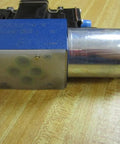 Directional control solenoid R978031711 2WE6Y62/EG24 N9DK24L2/62 24 VDC hydraulic valve, side view on wood surface