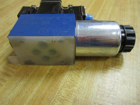 Directional control solenoid R978031711 2WE6Y62/EG24 N9DK24L2/62 24 VDC hydraulic valve, side view on wood surface