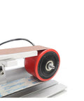 Close-up of Badass 600W Brushless Water Cooling Belt Sander And Polisher steel roller with sanding belt attachment.