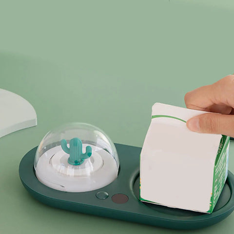 Smart Electric Cup Warmer Base with Three Adjustable Heat Modes holding a milk carton, stylish design with cactus detail.