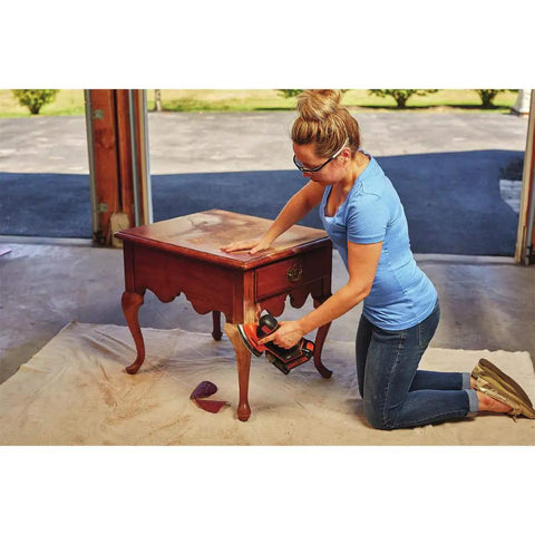 Woman sanding wooden table with 20V Max Mouse Sander Tool Only With Compact Ergonomic Design, dust collection, and detail finger attachment