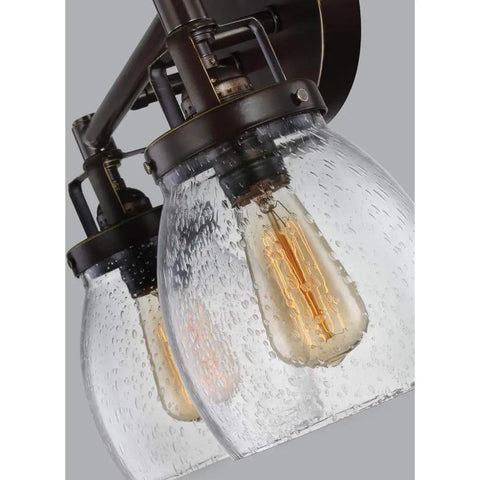 Close-up of Belton Collection four-light wall bath vanity fixture in Heirloom Bronze with seeded glass shades, transitional sconce.