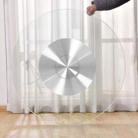 Person holding a heavy duty tempered glass lazy Susan turntable with non slip rubber feet, 8mm thick clear rotating serving plate.