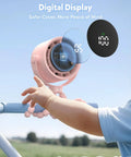 Baby's hand reaching for Rechargeable Clip On Baby Stroller Fan With Five Speeds, LED Display, 360 Degree Pivot on stroller handle.