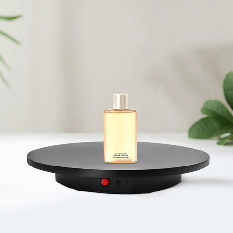 Smooth Electric Rotating Display Stand 360 Degree Turntable with Pure Copper Motor showcasing a bottle of shower gel on a sleek black platform.