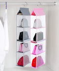 Space Saving Hanging Purse Organizer With Four Compartments For Closet Storage shown hanging with bags inside.