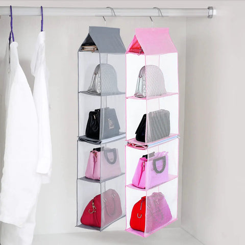 Space Saving Hanging Purse Organizer With Four Compartments For Closet Storage shown hanging with bags inside.