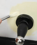 Person using Score Big On Crisp Trim Lines With This 4 Piece Paint Brush Set on wall around a doorknob.