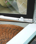 Hands-Free Hold Open Door Closer Kit For Medium And Lightweight Storm And Screen Doors, Tap Button Hold Open, Easy Release, Smooth Quiet Closing Motion, Black Finish, Durable Single Kit For Quick Install mounted on white doorframe
