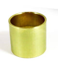 Brass sleeve bearing isolated on white background, cylindrical tube shape with smooth surface.