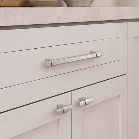 Close-up view of 10 Pack Brushed Nickel Single Hole Kitchen Cabinet Knobs on white cabinets, showcasing sleek anodized aluminum finish.