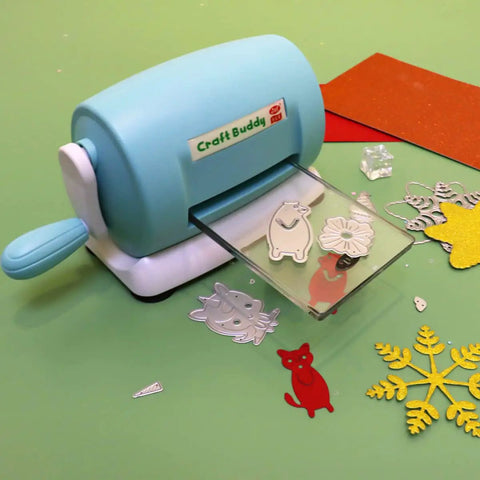 DIY Die Cutting And Embossing Machine For Crafting Scrapbooking Card Making And Papercrafts on a table with cut shapes
