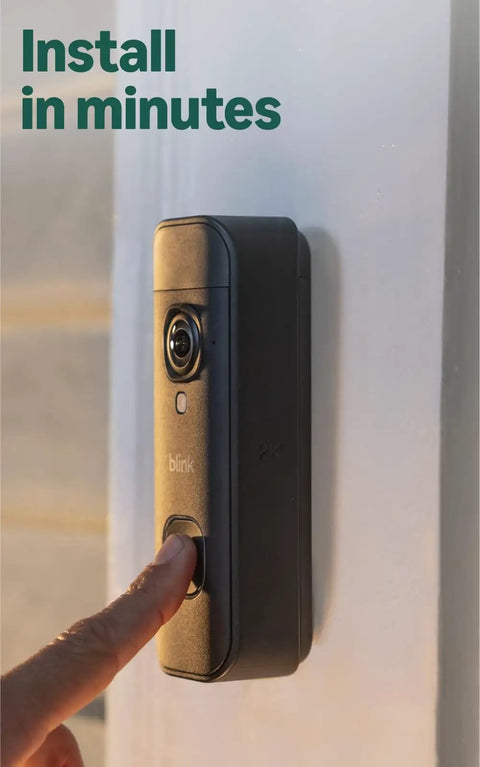 Wireless Video Doorbell Packing 2K Resolution And Long Battery Life With Snappy Audio Clarity Head To Toe Frame Smart Motion Alerts Installs Like A Breeze Includes Sync Module Core Matte Black mounted on a wall.