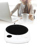 This Solid Electric Mug Warmer Boasts Four Heat Presets To Keep Your Daily Brew Piping Hot All Day Long Featuring Smart Auto Shut Off Protection And Fast Heating With A Sleek White Top For Desk Setup, with a woman and laptop.