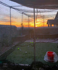 Sunset view through multicolor Heavy Duty Twisted Poly Baseball And Softball Batting Cage Net 30 by 12 by 10 Feet with sag resistant ropes