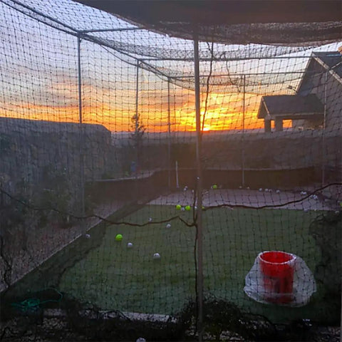 Sunset view through multicolor Heavy Duty Twisted Poly Baseball And Softball Batting Cage Net 30 by 12 by 10 Feet with sag resistant ropes