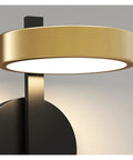 Close-up of a sleek Nordic Iron Wall Sconce with a gold shade, offering chill warm white glow for hangout spots.