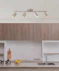Pratt 4 Light Track Lighting Fixture in Brushed Nickel With Pivoting Heads above modern kitchen island