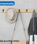 Stainless Steel Wall Hooks A Badass 10 Piece Set For Hanging Coats Robes And Heavy Duty Screw Mount Holder For Bedroom Kitchen Bathroom Decor Plus Super Slick Finish And Rock Solid Everyday Organization System, showing wall-mounted hooks holding a hat and a jacket.