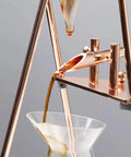 Top Tier Iced Coffee Maker And Cold Brew Drip Tower With 800Ml Borosilicate Glass Pitcher pouring coffee into a glass.