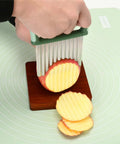 COLGRE vegetable chopper with green handle and stainless steel crinkle/wavy blade slicing potato on wooden board